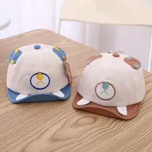 Detailed view of baby cartoon baseball hats with bear ears on a wooden surface