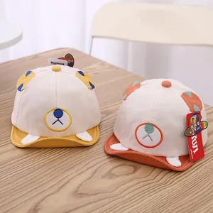 Detail of baby baseball hats with cute 3D ears and cartoon face embroidery on cotton fabric