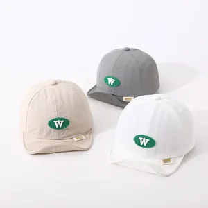 Detailed view of quick-dry cotton baby baseball caps in beige, gray, and white colors