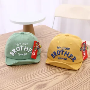Solid color baby baseball cap with George embroidery in green and yellow tones