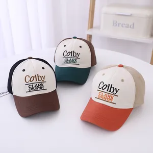 Kids baseball cap with Colby Clark embroidery in brown, green, and orange color block