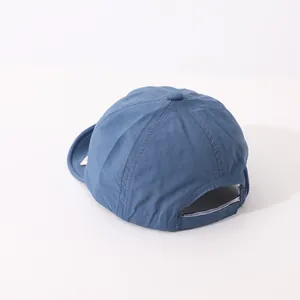 Detail view of the adjustable strap and back opening on the blue quick-dry baby cap