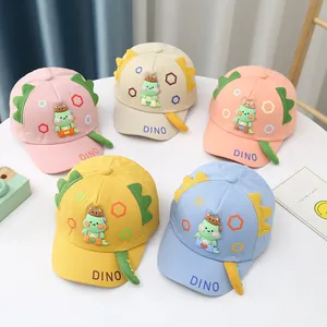 Detail of colorful cotton baby baseball hats with 3D cartoon dinosaur fins and embroidery