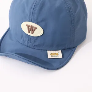 Close-up of quick-dry blue toddler baseball cap with leather W patch and brand tag