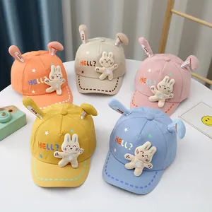 Detailed overhead view of kids' cotton bunny ear baseball caps in five vibrant colors