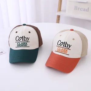 Close-up of embroidered Colby text on two-tone cotton kids baseball caps with vintage style