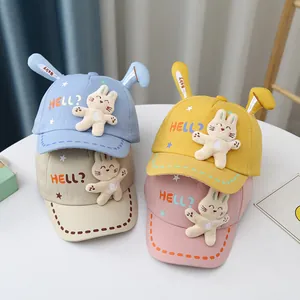 Detail of baby cotton baseball caps with plush bunny ears and embroidery in four soft colors