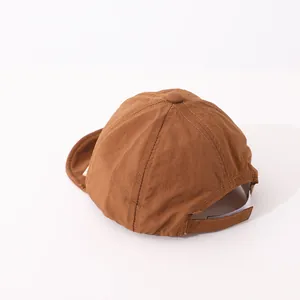 Detail view of brown quick-dry baseball cap with adjustable velcro strap and soft texture