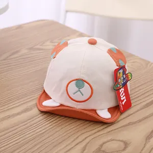 Close-up of baby baseball cap with cute bear ears embroidery and orange visor detail