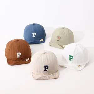 Detail of infant soft brim baseball caps in five colors with embroidered P letter