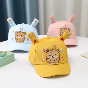 Detailed shot of baby cotton baseball caps with animal ears and cartoon bear embroidery