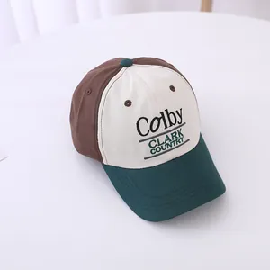 Close-up of tricolor baseball cap featuring retro Colby Clark Country embroidery