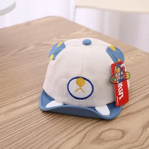 Close-up of cotton baby baseball cap with cute bear ears and embroidery on wood table