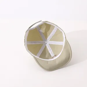 Detailed inner view of beige quick-dry baby cap showing soft lining and velcro strap