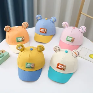 Detail of cute baby baseball caps in five vibrant color combinations with bear ear accents