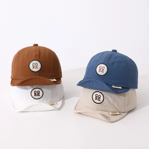 Detailed view of lightweight kids baseball caps in brown, blue, white and beige colors