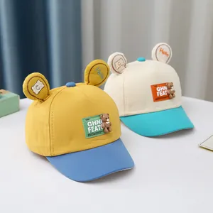 Detail of color-block baby baseball caps with cute 3D bear and embroidered ears