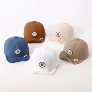 Flat lay of colorful quick-dry cotton baby baseball caps with soft brims and CORE patches