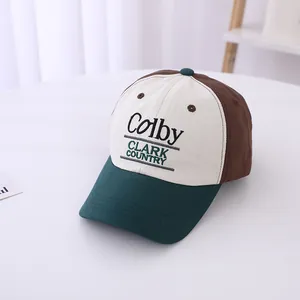 Detail of embroidered Colby text on a three-color patchwork baseball cap for kids