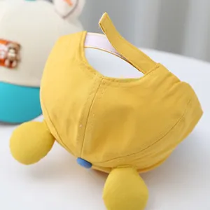 Detail of yellow toddler baseball cap with cute plush ears and adjustable strap
