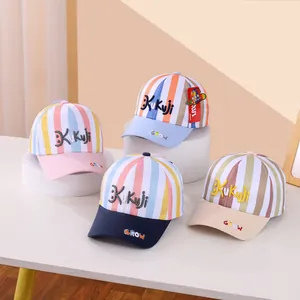 Detail view of colorful striped baseball caps for kids with Kukuji and Grow embroidery