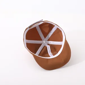 Detailed interior view of a brown kids baseball cap with reinforced seams and adjustable strap