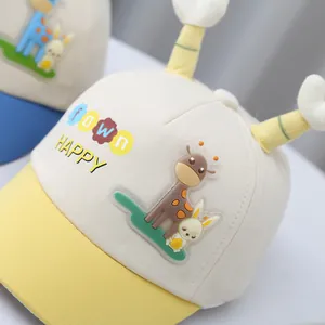 Detail of baby cartoon baseball cap with giraffe patches and yellow decorative antennae