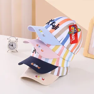 Detail of colorful striped kids baseball caps in pastel blue, pink, and navy tones