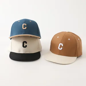 Gedetailleerd borduursel van de letter C op gekleurde katoenen baseballpetten voor kinderen