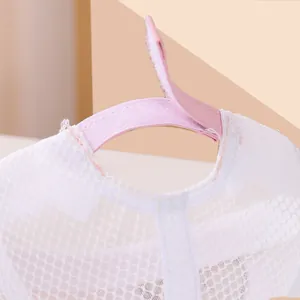 Detailed view of breathable mesh baby hat with adjustable pink hook and loop strap