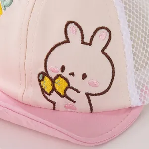 Macro view of pink baby mesh cap featuring cute rabbit embroidery and breathable fabric