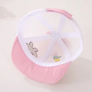 Detail of pink mesh baby hat featuring soft embroidery of a cute rabbit and velcro strap