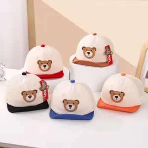 Detail of baby mesh caps showing cute bear embroidery and breathable fabric texture