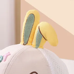 Detail of baby mesh cap featuring cute 3D yellow bunny ears and soft cotton fabric