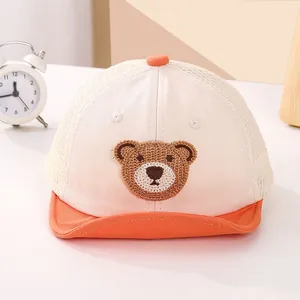 Close-up of baby mesh baseball cap with cute bear embroidery and breathable summer fabric