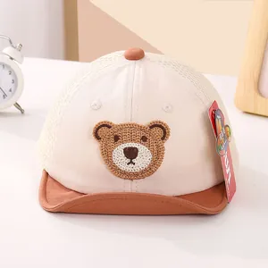 Detail of baby summer mesh cap featuring a cute knitted bear patch and short brim