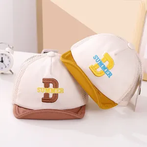 Detail of mesh baby baseball caps with 3D letter B embroidery in soft summer tones