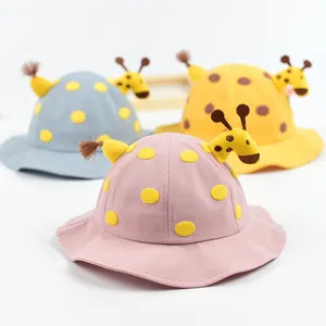 Cute giraffe-themed baby sun hats in pink, blue and yellow with colorful polka dot patterns