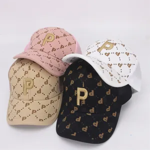 Detailed close-up of kids mesh baseball caps with gold P embroidery and pattern