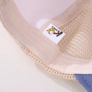 Close-up of beige mesh baby hat interior showing breathable fabric and neat stitching