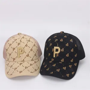 Close-up of golden P embroidery on breathable mesh baseball caps for children