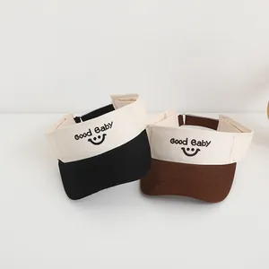 Kids open top sun hat with Good Baby embroidery and smiley face in beige and black