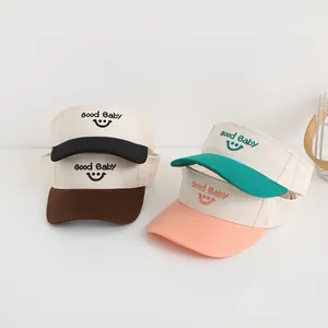 Detail of four colorful Good Baby smiley face embroidery open top sun hats for kids