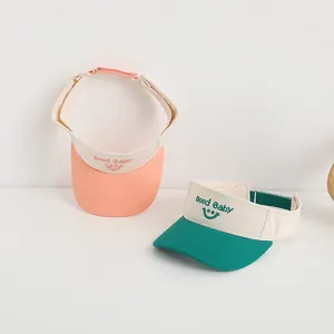 Child sun visor hats with Good Baby smile embroidery in pink and dark green