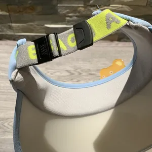 Detail view of adjustable buckle and elastic strap on a children sun visor hat