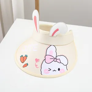 Close-up of bunny ears and cartoon rabbit patterns on a cream sun visor hat