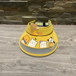 Detail of yellow kids sun visor with cartoon animal prints and adjustable strap
