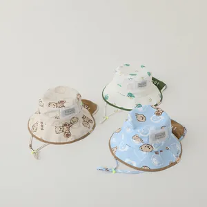 Kids sun hats with neck flaps and cartoon prints in beige, white, and light blue colors