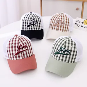 Close-up of mesh trucker hats with Frog embroidery in four classic plaid colors