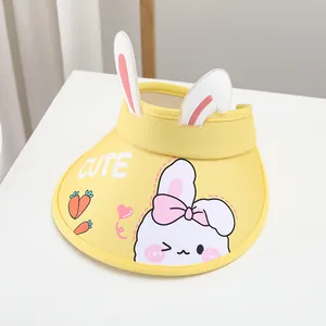 Detail of yellow kids visor hat with 3D bunny ears and cute cartoon rabbit print